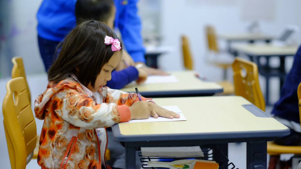 A child working at a school desk