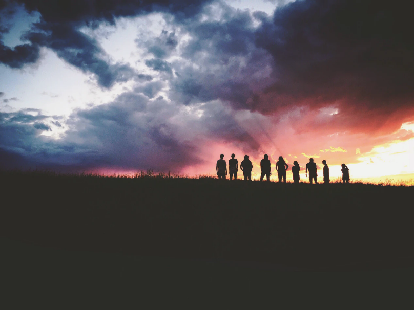 a group of people enjoying a sunset